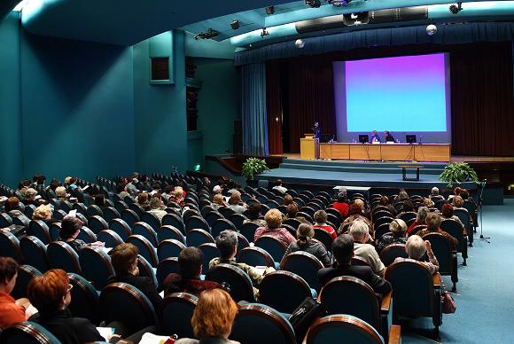 People seated in hall for conference meeting