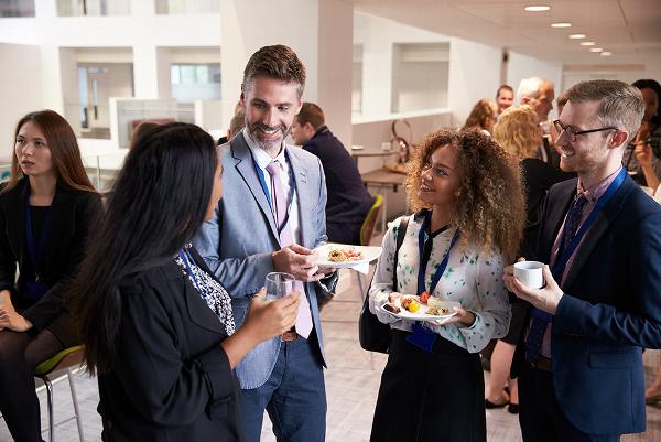 Group of smiling professionals talking at conference