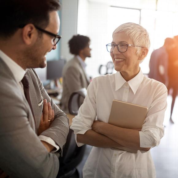 Smiling woman and man talking at networking event